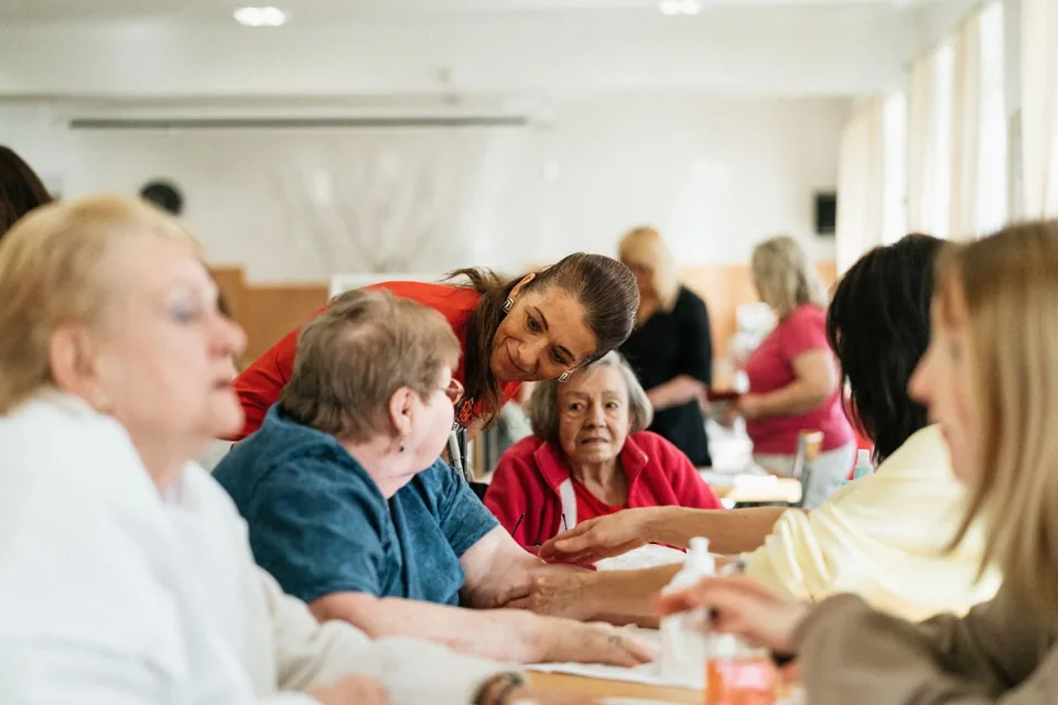 A group of adults talking around a table.