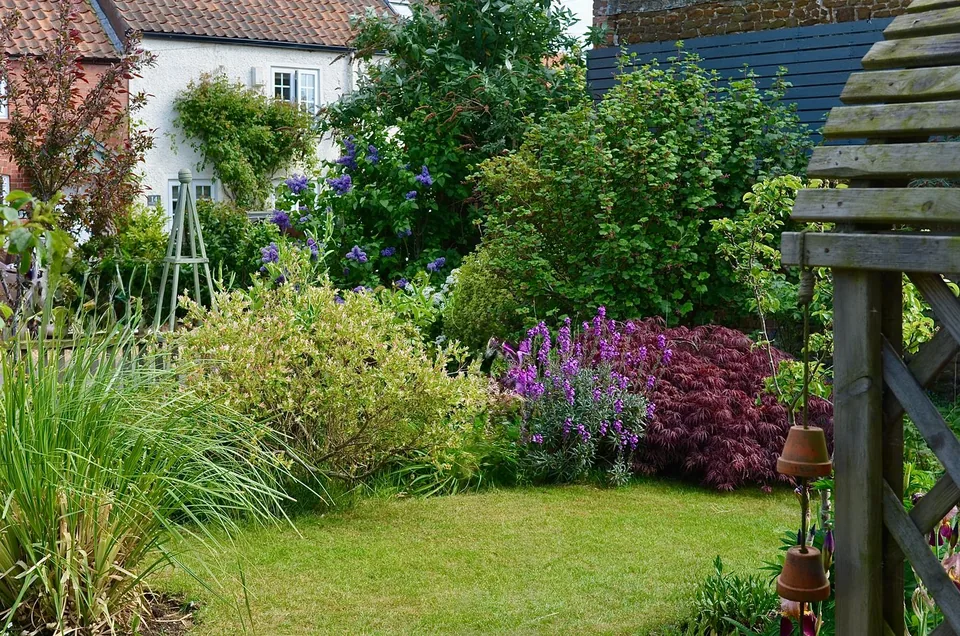 A cottage garden with colourful flowers and outdoor seating.